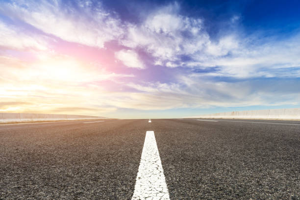 istock New asphalt road and beautiful sky clouds at sunrise 1000492692