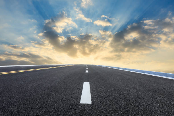 istock New asphalt road and beautiful sky clouds at sunrise 1000493122