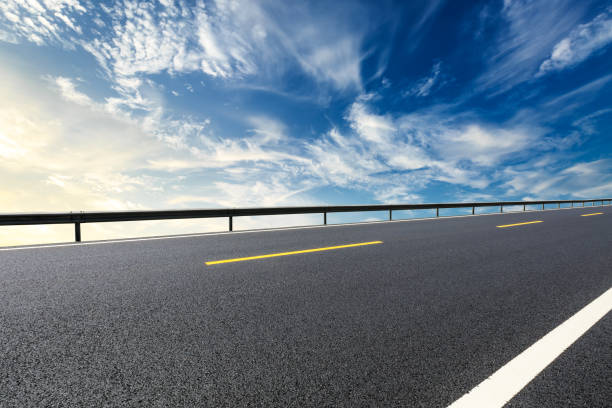 istock New asphalt road and beautiful sky clouds at sunrise 1000493586