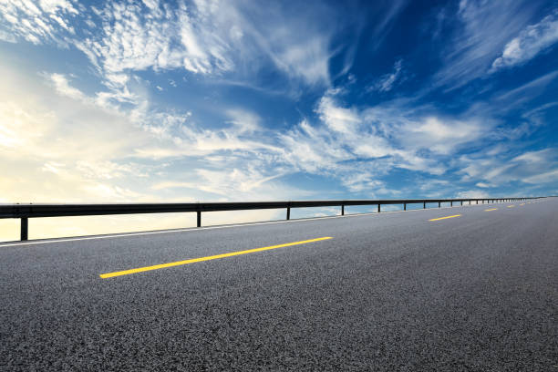 istock New asphalt road and beautiful sky clouds at sunrise 1000493588
