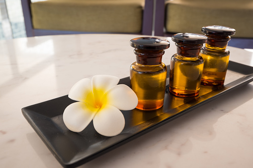 Bottle Of Essential Oil And Jasmin Flower With Plumeria Flower Setup On  Marble Table For Spa Relaxing Massage At Thailand Stock Photo - Download  Image Now - iStock