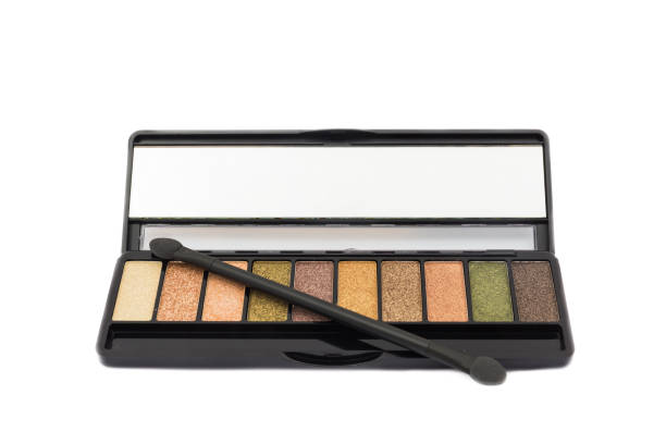 istock Colorful eye shadow palette makeup products and brush make up isolated on white background. Clipping path for use and select focus. 1000493920