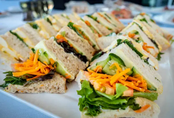Photo of Freshly prepared sandwiches arranged on a large plate
