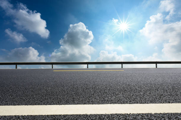istock Empty asphalt road and beautiful sky clouds landscape 1000497494