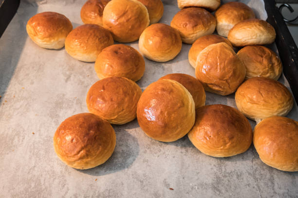 closeup bread rolls in mold on wood table and copy space background. - pão doce imagens e fotografias de stock