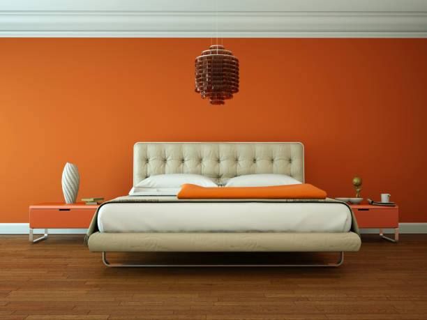 istock modern bedroom with orange wall and modern decor 1000504812