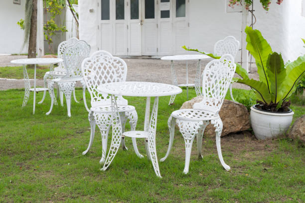 istock White vintage chairs and table in the garden 1000505894
