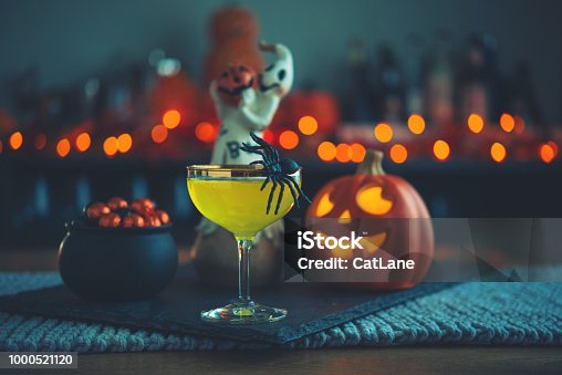istock Halloween time. Vibrant colored drinks with cauldron of candy 1000521120