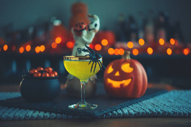 Halloween time. Vibrant colored drinks with cauldron of candy Halloween time. Vibrant colored drinks with cauldron of candy cauldron photos stock pictures, royalty-free photos & images