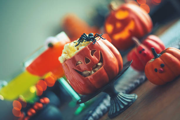 istock Halloween time. Vibrant colored drinks with cauldron of popcorn 1000521126