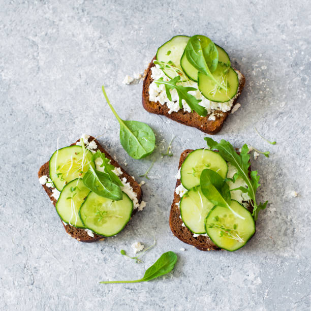 istock Healthy open sandwichis with fresh vegetables and soft cheese 1000540412