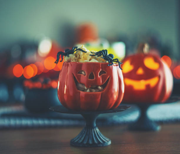 istock Halloween time. Vibrant colored drinks with cauldron of popcorn 1000544312
