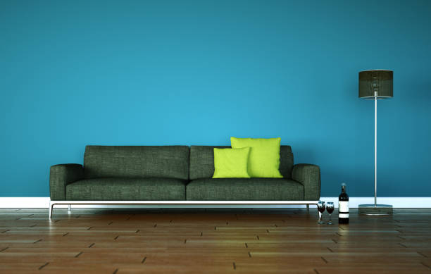istock Bright room with grey sofa in front of a blue wall 1000551470