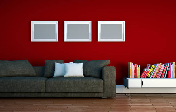 istock Bright room with grey sofa in front of a red wall 1000554196