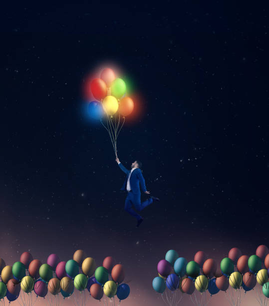 istock Man flying with colorful  glowing balloons. 1000564716