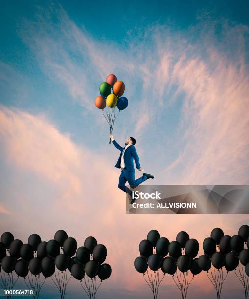Man Flying With Colorful Balloons Stock Photo - Download Image Now - Contrasts, Passion, Concepts