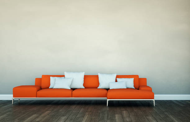 istock Bright room with orange sofa in front of a grey wall 1000583166