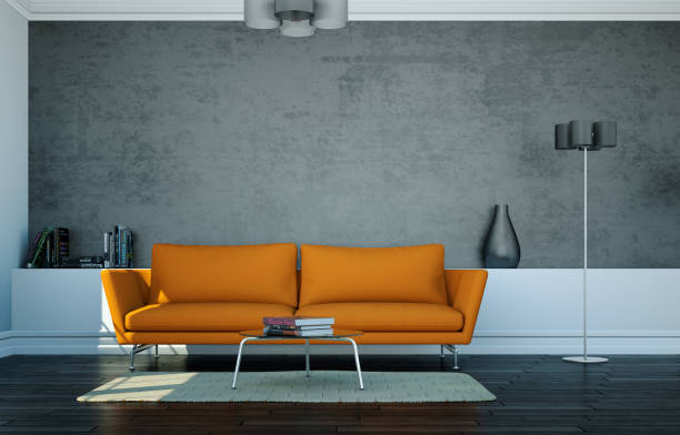 istock Bright room with orange sofa in front of a grey wall 1000583742