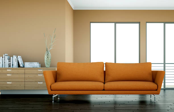 istock Bright room with orange sofa in front of a brown wall 1000591186