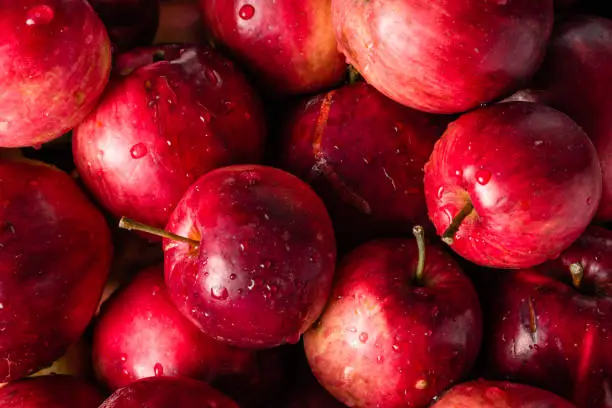 Red apples background, pile of fresh apple fruits, natural texture