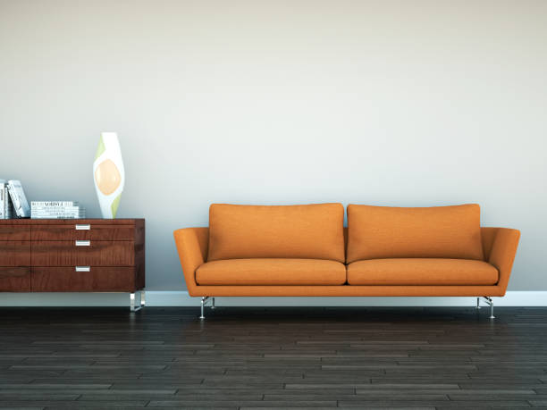 istock Bright room with orange sofa in front of a brown wall 1000597554