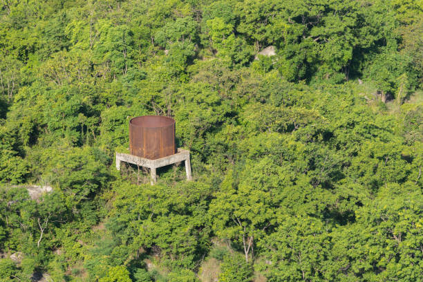 istock Big water tank abandoned in green forest 1000656172