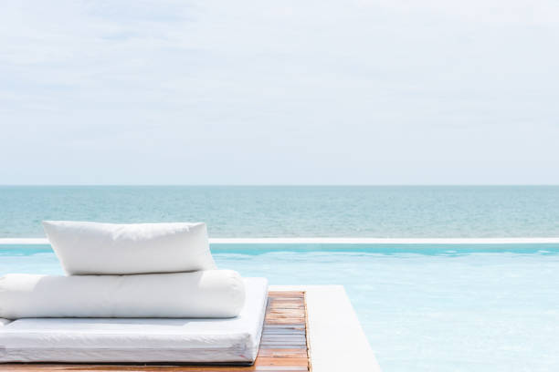 istock White bed at pool seaside the sea with horizon sky 1000656640