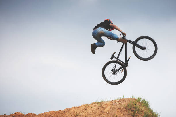 istock mtb dirt rider doing trick on a jump 1000661248
