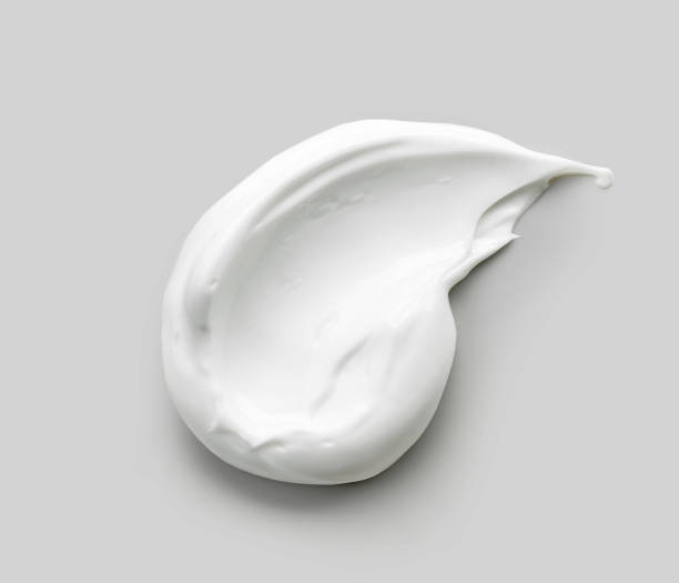 white cosmetic cream white cosmetic cream on grey background for sale flash stock pictures, royalty-free photos & images