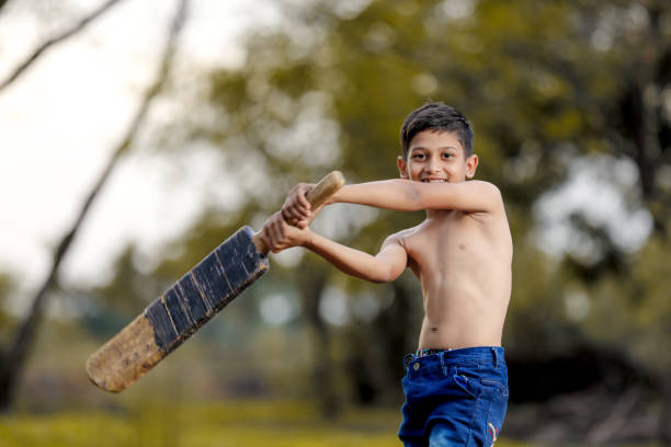 istock Rural Indian Child Playing Cricket 1000664700