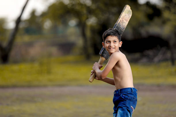 istock Rural Indian Child Playing Cricket 1000665066