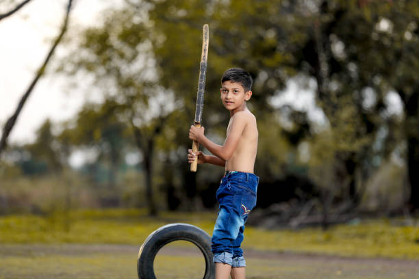 istock Rural Indian Child Playing Cricket 1000665702
