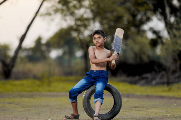 istock Rural Indian Child Playing Cricket 1000668208