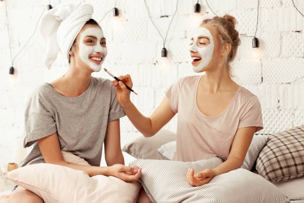 Joyful friends having funny beauty day