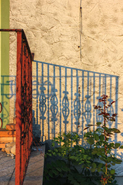 istock vintage eldered red fence house entrance 1000680760