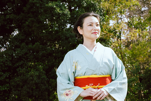 Portrait of an Asian woman wearing a kimono at the park