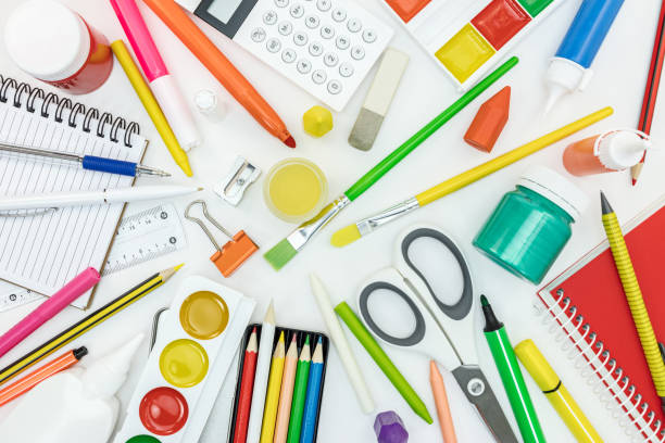 istock variety of school tools and office supply items on white desk 1000691166