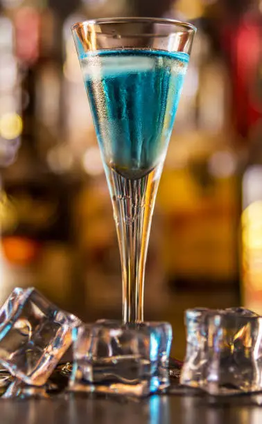 Photo of refreshing liqueur in a tall glass, alcoholic drink prepared by the bartender