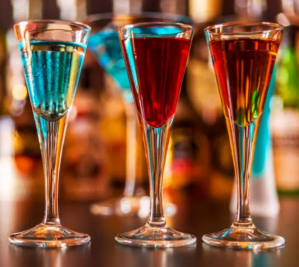 Photo of refreshing liqueur in a tall glass, alcoholic drink prepared by the bartender