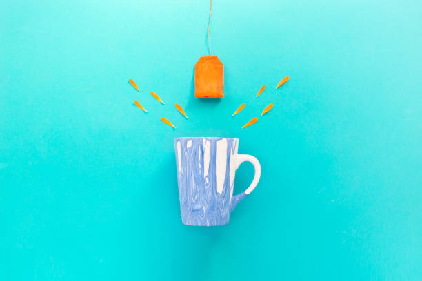 Creative composition background. Blue cup orange tea and petals. Flat lay. Copy space. Top view