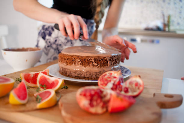 istock Young woman cooking a cake in the kitchen. 1000711840