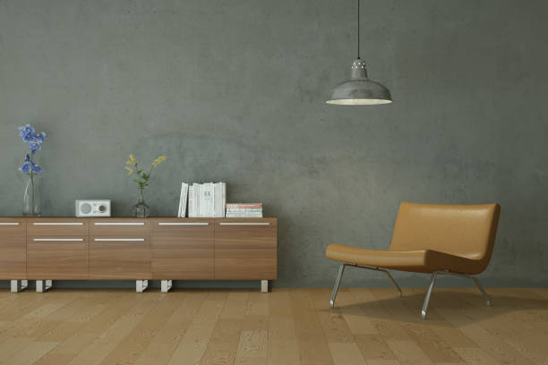 istock Bright room with brown chair in front of a grey wall 1000717164