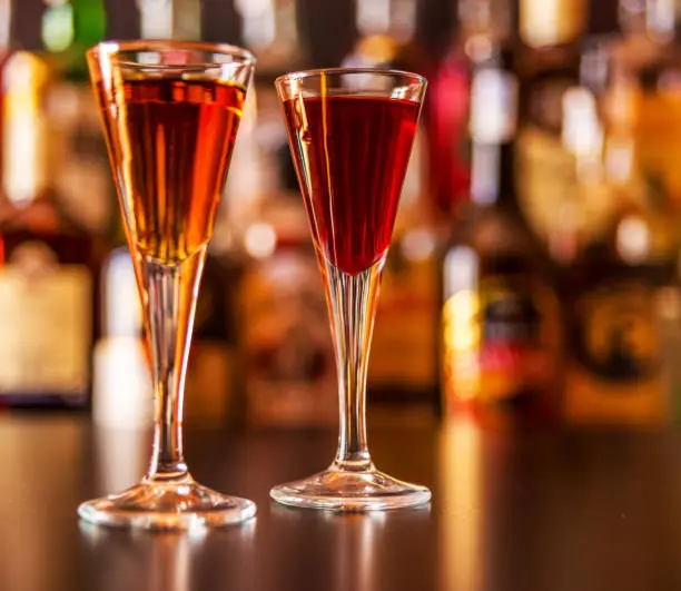 Photo of refreshing liqueur in a tall glass, alcoholic drink prepared by the bartender