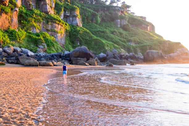 istock Mature woman walking along the coast 1000731294