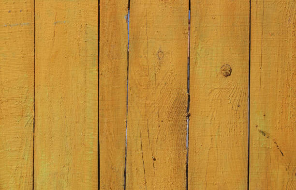 istock Yellow vintage painted wooden panel background 1000742550