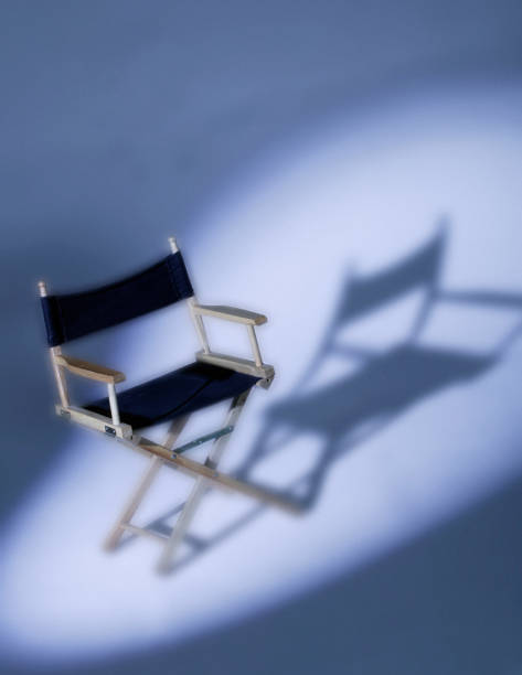 istock DIRECTORS CHAIR IN SPOTLIGHT 1000750538