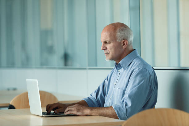 istock side view of main working on laptop 1000750694