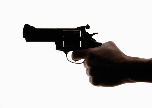 istock HAND HOLDING REVOLVER 1000753238
