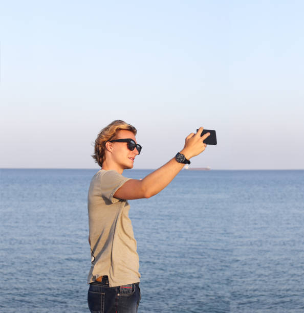 istock Teenage boy using smart phone.Selfie 1000755800