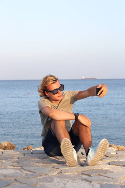 istock Teenage boy using smart phone.Selfie 1000755804